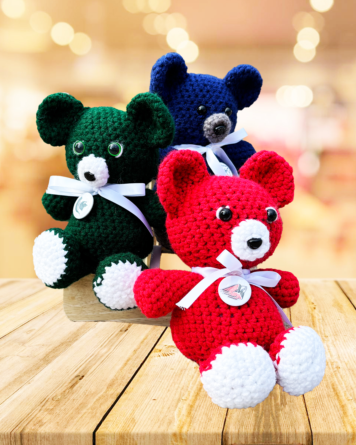 Stack of 3 crochet bears for different teams to show crochet bear order options